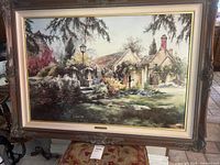 Framed detailed landscape print of English countryside garden with cottage and greenery, showing overall condition and framing.