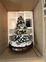 Boxed Thomas Kinkaid Village Christmas illuminated tree with original styrofoam packing.