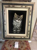Full frontal image of the framed painting of a kitten on black velvet with rustic styled frame.