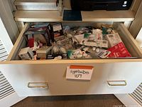 Wide drawer filled with numerous boxed and loose light bulbs of various types