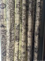 Curtain panels showing vintage map print fabric with sailing ships and explorer cartography pattern.