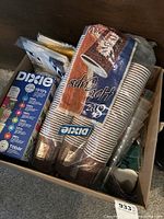 Large box filled with 80+ Dixie brown and white 8 oz hot cups, some clear plastic cups, and napkins.