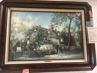 Framed print showing the 'Penhurst Tea Rooms' scene with detailed artwork and dark wooden frame with floral carvings.