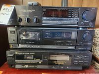 Photo of a three-piece stereo set showing a Treo Audio-Video Control Center, a Sony cassette deck, and a DOTE equalizer stacked vertically.
