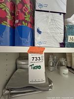 Close-up photo of various Kleenex tissue boxes and Puffs Ultra Soft tissues on a shelf, showing floral patterns and brand logos