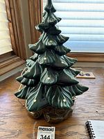 Front view of the green ceramic Christmas tree with multiple holes for lighted bulb ornaments; glossy surface with layered, leafy branches.