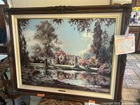 Frontal view of framed 'Wakehurst Place' print showing ornate wooden frame, matting, image.