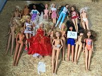 All 18 dolls laid out showing varied outfits and conditions