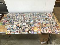 Wide view showing entire spread of loose baseball cards laid out on table