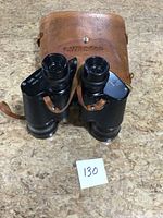 Full view of binoculars with leather case