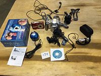 Overall lot including Canon camera, Sanyo camera, Magic Cam webcam with box, Vivitar monocular and accessories