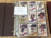 Front view of first binder page showing nine 1980s O-Pee-Chee cards and handwritten note stating 107 cards 1980s & 90s