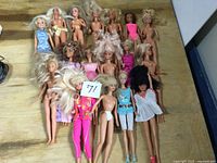 Group of 17 dolls on table