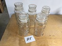 Five Planters jars grouped on table showing overall condition