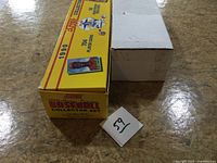 Closed yellow 1990 Score Collector Set box beside plain cardboard box