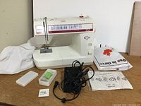 Front view of White Model 955 sewing machine with accessories