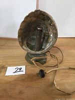 Front view showing abalone shell shade, lighthouse base, power cord and plug