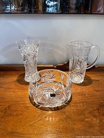 Full set of three heavy crystal items displayed: vase, pitcher, and bowl showing pinwheel pattern.