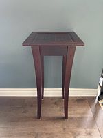 Front view of the solid wood plant stand showing shape and finish.