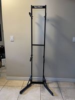 Front view of the black metal SportRack standing bike holder showing its height, upright frame and two adjustable arms for holding bikes.