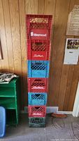 Photo of stacked milk crates showing various colors and brands including Silverwood and Sealtest.