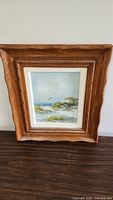 Full view of framed painting showing beach scene with seagulls and wooden frame
