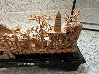 View showing natural cork-like stone base with pagoda tower and several wooden trees, part of the Asian decorative sculpture.