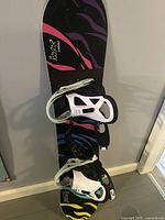 Full view of Burton Chopper Safari 120 snowboard with white bindings attached.