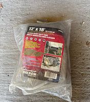Clear plastic sealed packaging showing label with tarp dimensions 12 x 18 ft and brand Erickson Manufacturing.