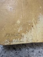 Close-up of handwritten inscriptions on wood, possibly indicating origin or maker.