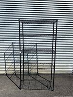 Full view of 5 tier black metal wire shelf storage rack with 5 shelves and tubular frame.