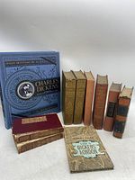 Books grouped standing and lying down showing spine titles and cover designs