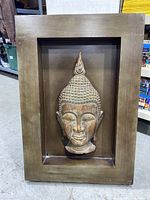 Front view of boxed wall art featuring a Buddha head sculpture within a deep wooden frame.
