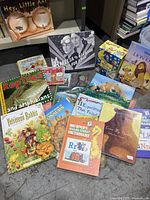 Grouping of various children's books displayed, showing titles and condition.