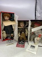 Three Knowles collectible dolls in original boxes with some documentation, dolls need cleaning.
