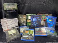 Collection of various movie DVDs and Blu-rays, some still shrink wrapped, showing front covers and spines of the titles.