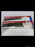 Two boxed Velleman advertisement LED display kits with visible 'Your Message' example on packaging.