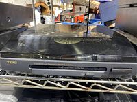 Front angled view of TEAC P-A400 turntable showing the black casing and visible record inside dust cover.