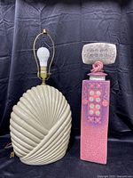 Photo showing both the painted wood table lamp and the colorful tall ceramic vase next to each other on a black background.