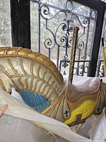 Side view of horse showing carved mane, painted saddle and decorative crosses