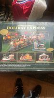 Box showing Holiday Express Animated Christmas Train Set with detailed holiday decoration illustration.