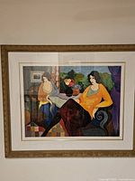 Full view of framed lithograph under glass, showing ornate gilded wood frame and off-white mat