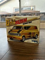 Front view of original box showing colorful illustration of 1978 Gold Rush Custom Dodge Van model in yellow with gold and black decals.