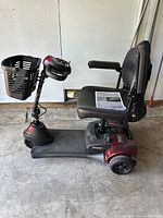 Full side view of burgundy and black scooter with front basket and seating