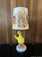Full view of the vintage Sesame Street Big Bird table lamp showing the yellow Big Bird figure base and colorful character lampshade
