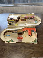 Photo of the vintage Hot Wheels 1979 Service Center playset showing two-level structure with car wash, parking and bike transmissions graphics.