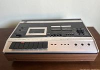 Front angled view of the Dual 901 cassette deck showing wood panel sides, black push buttons, and control layout.