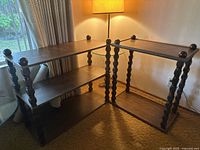 Set of two vintage mid-century wooden shelf tables configured in an L-shape, showing spindle legs with rounded finials on top and three shelves per unit.