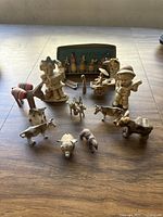 Front view of the vintage porcelain and quartz figurines, showing musicians, animals, and a small painted decorative set.