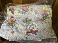 Photo showing the full comforter blanket with multiple Sesame Street characters printed including Oscar the Grouch, Ernie, Bert, and others.